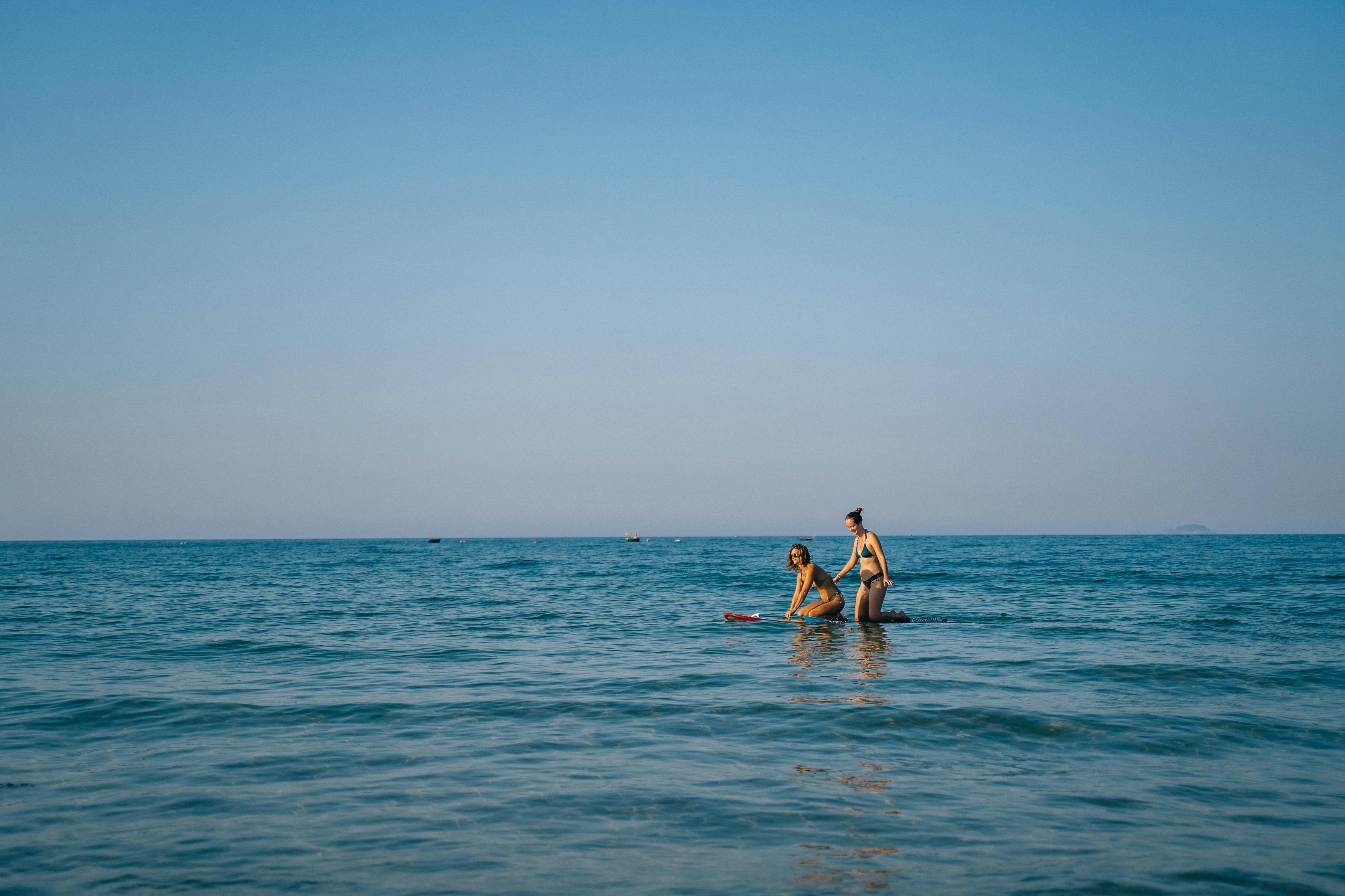 Girls in Bikini Standing on Beach · Free Stock Photo