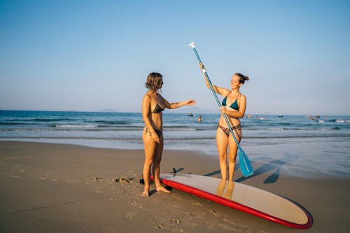 Women holding Paddle at the Beach