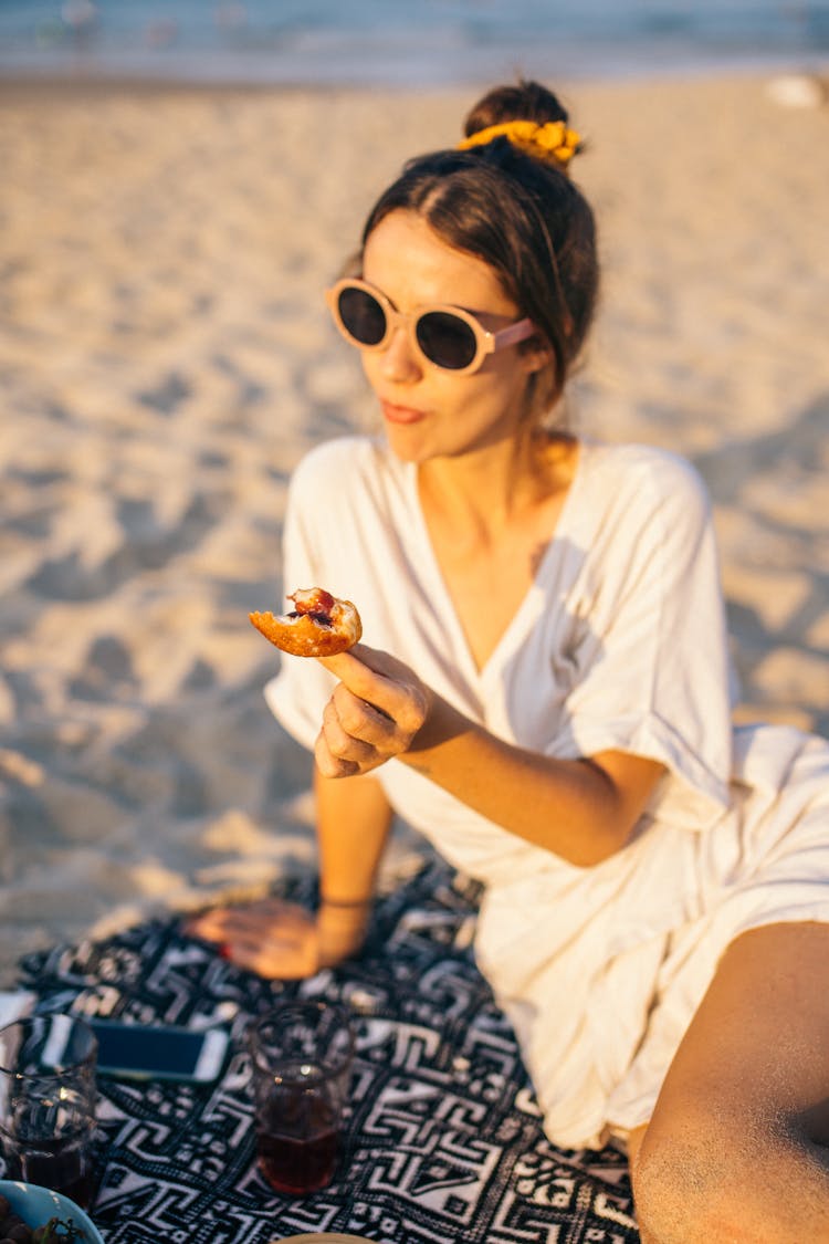 Woman In White Dress Eating Bread