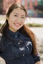 Smiling Woman in Blue Denim Button Up Jacket