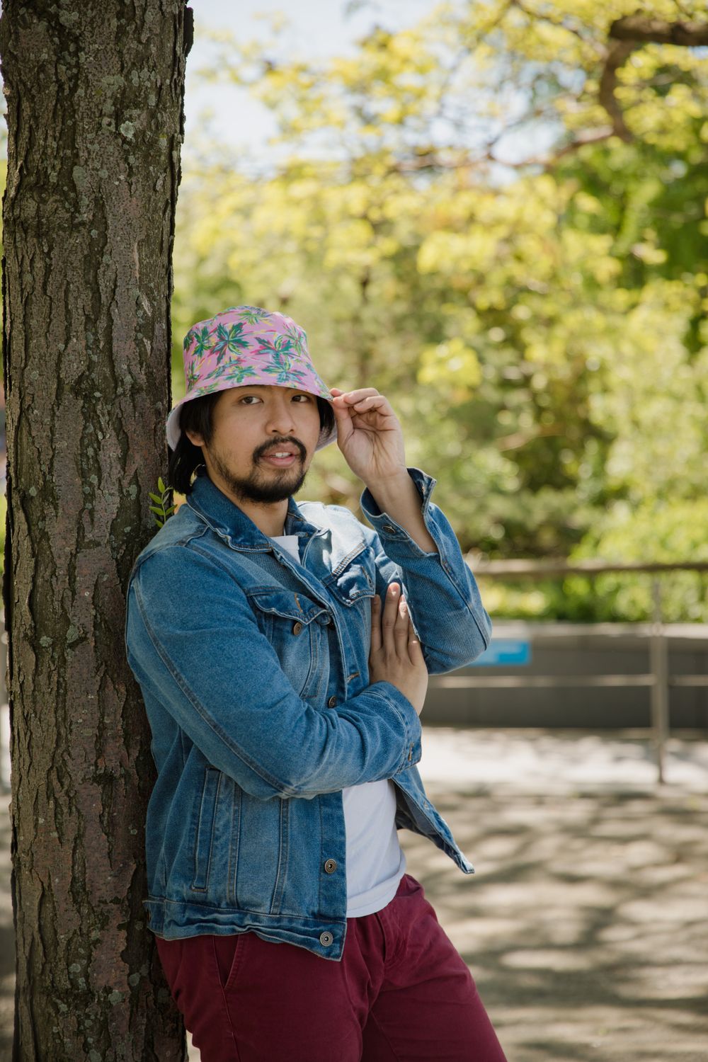 A Man in Denim Jacket Leaning on the Tree · Free Stock Photo