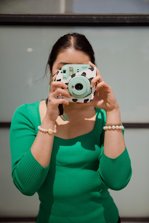 Woman Holding a Instant Camera