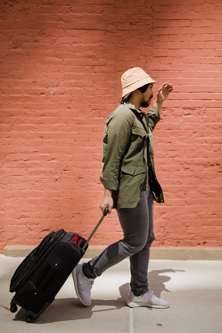 Side View Of Man Walking With Luggage