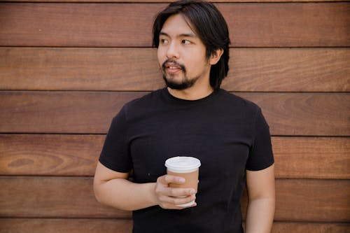 Free Man Holding a Disposable Coffee Cup Stock Photo