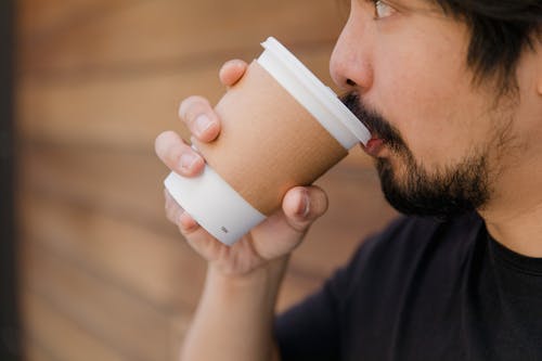 Free Man in Black Shirt Drinking from White Disposable Cup Stock Photo