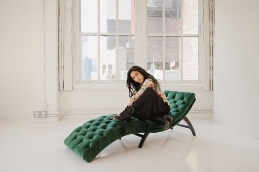 Man Sitting on Green Velvet Chaise Lounge