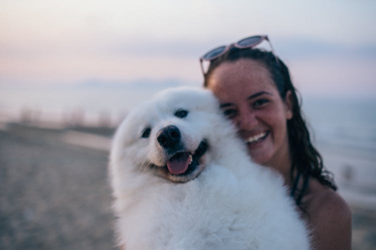 A Woman Carrying A Dog