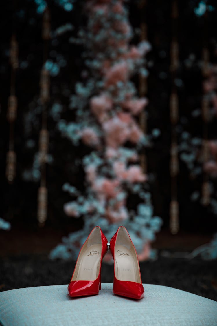 A Pair Of Red Stilettos On A Flat Surface