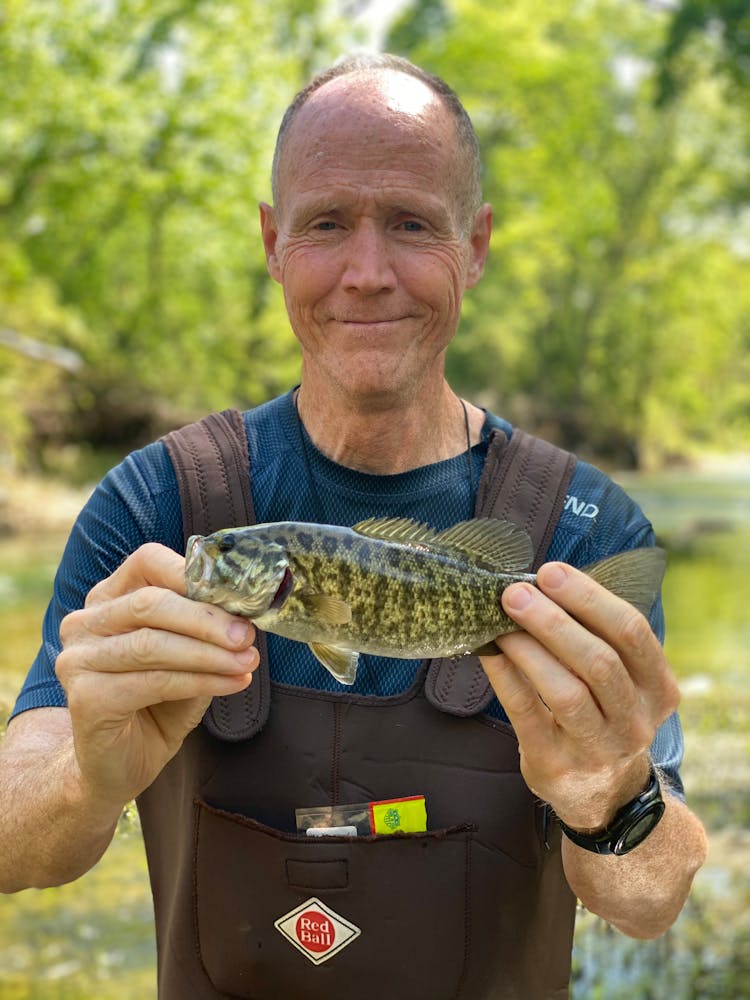 A Man Holding A Fresh Fish