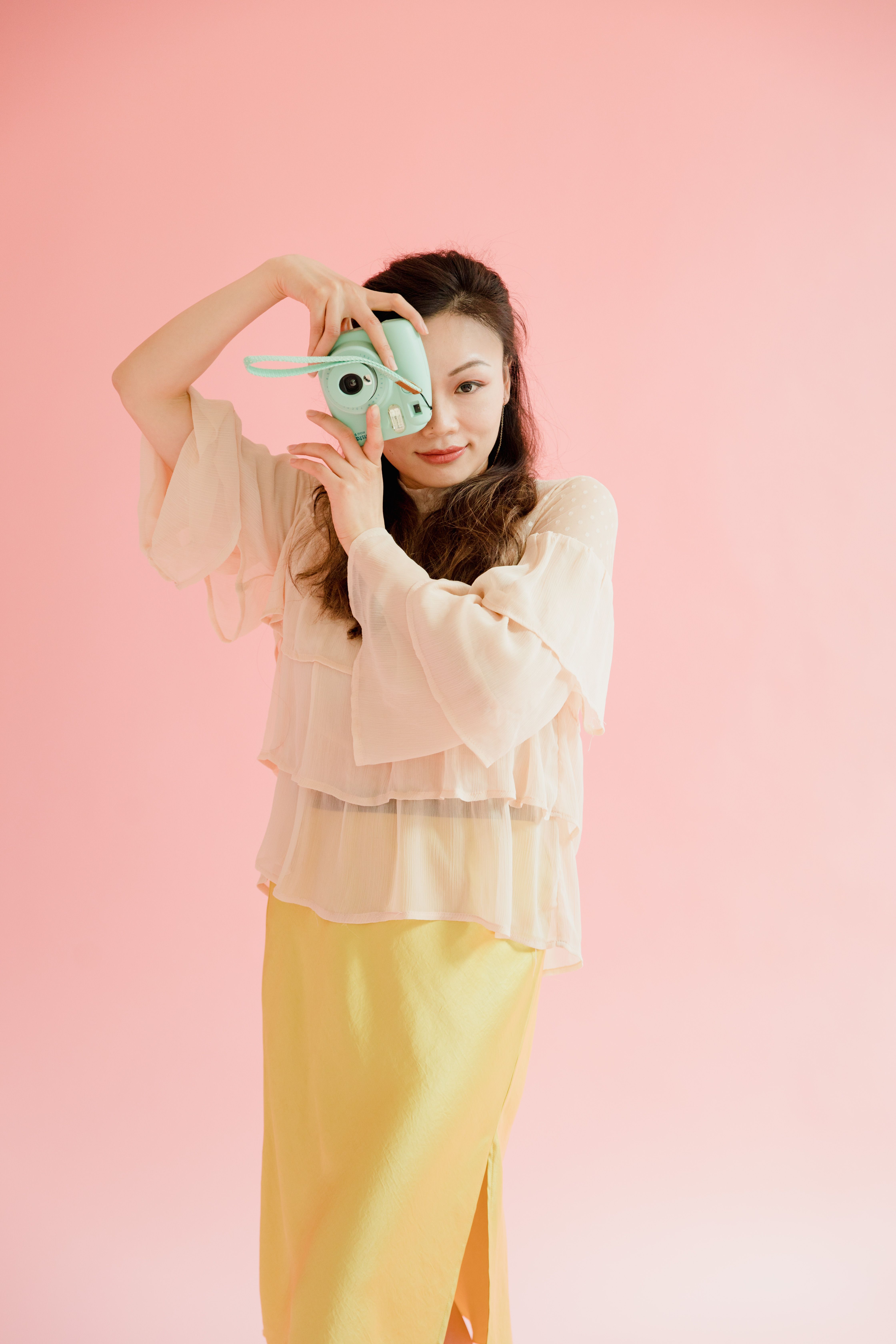 A Woman Posing With A Polaroid Camera Free Stock Photo a-woman-posing-with-a-polaroid-camera-free-stock-photo
