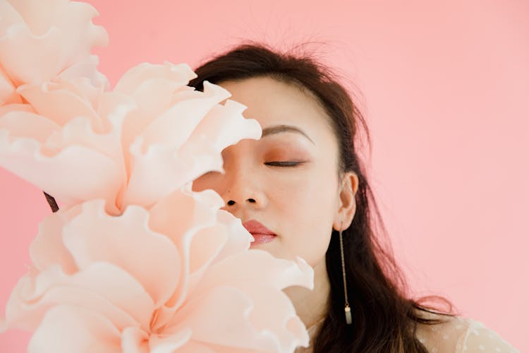 A Woman Smelling The Flower