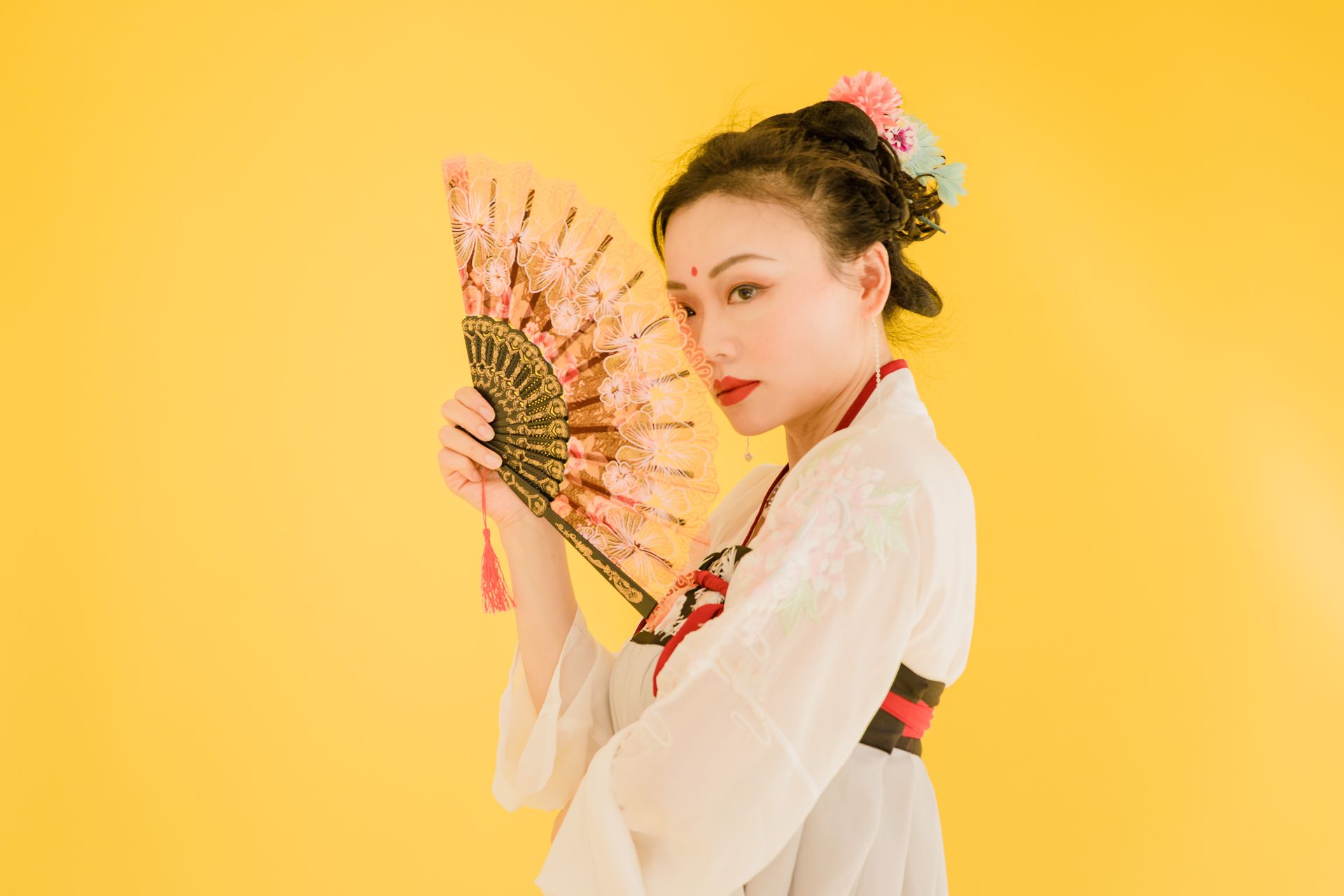 A Woman Covering Her Face with a Fan