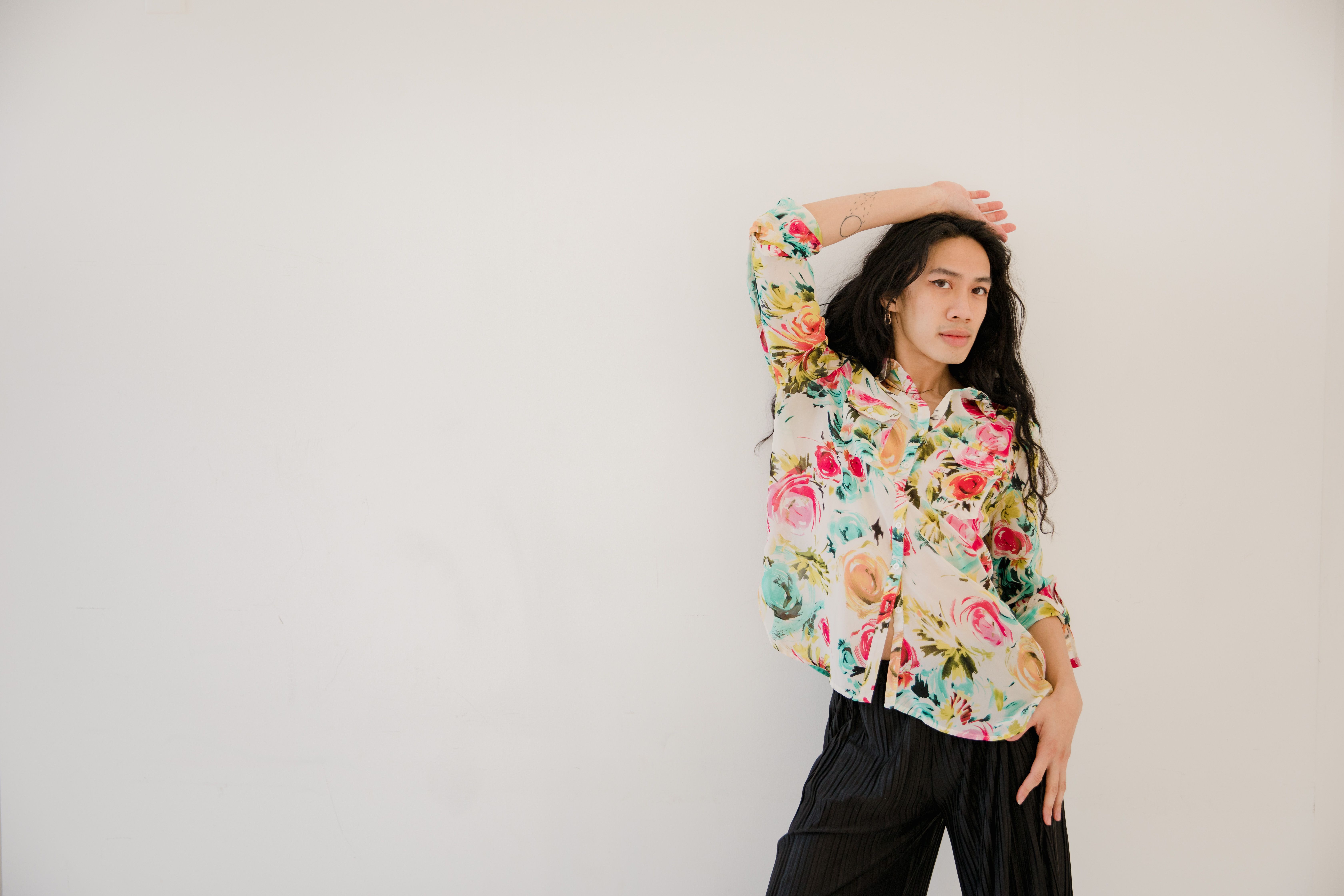 A Woman in Floral Top Posing with Her Hand on Her Head · Free Stock Photo