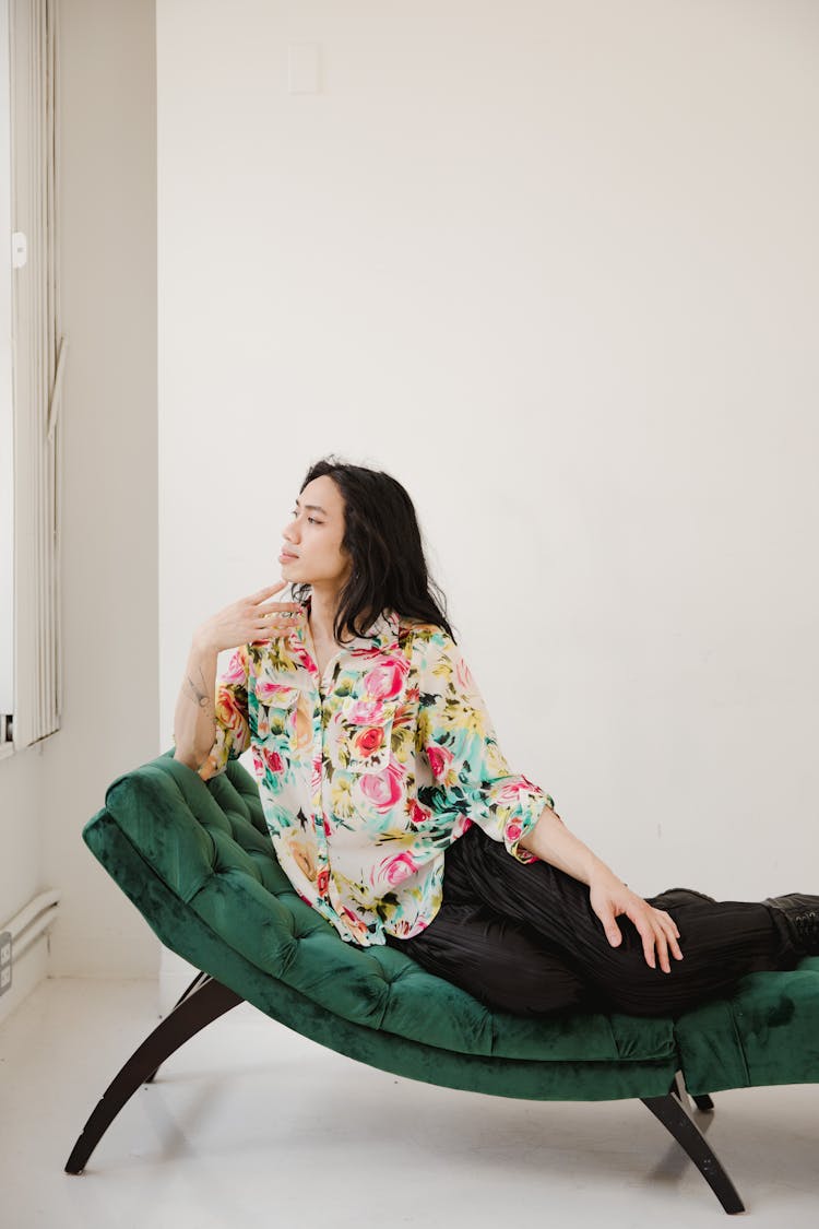 A Model Posing On A Green Couch