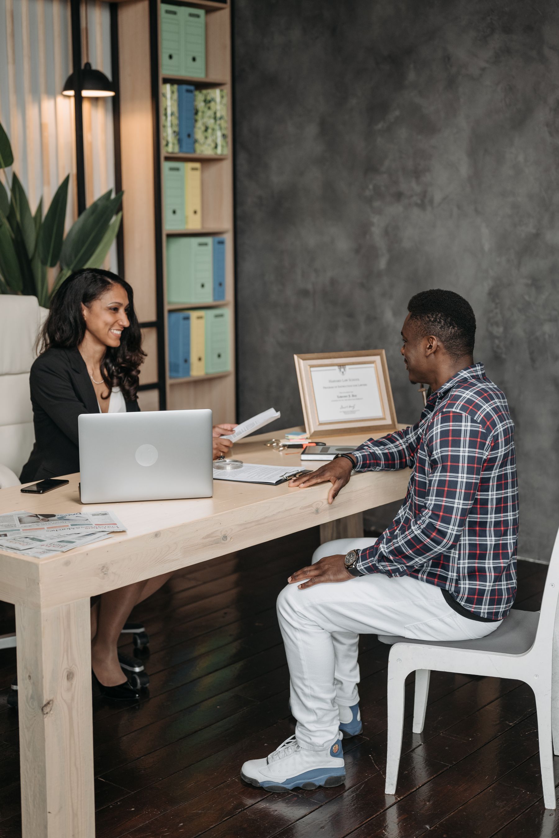 Professional lawyer and client discussing documents during a confidential legal consultation