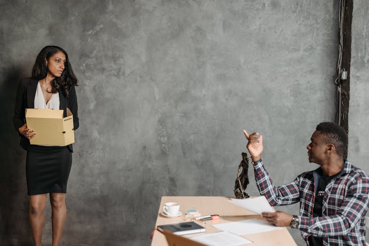 A Man And Woman Talking In The Office 