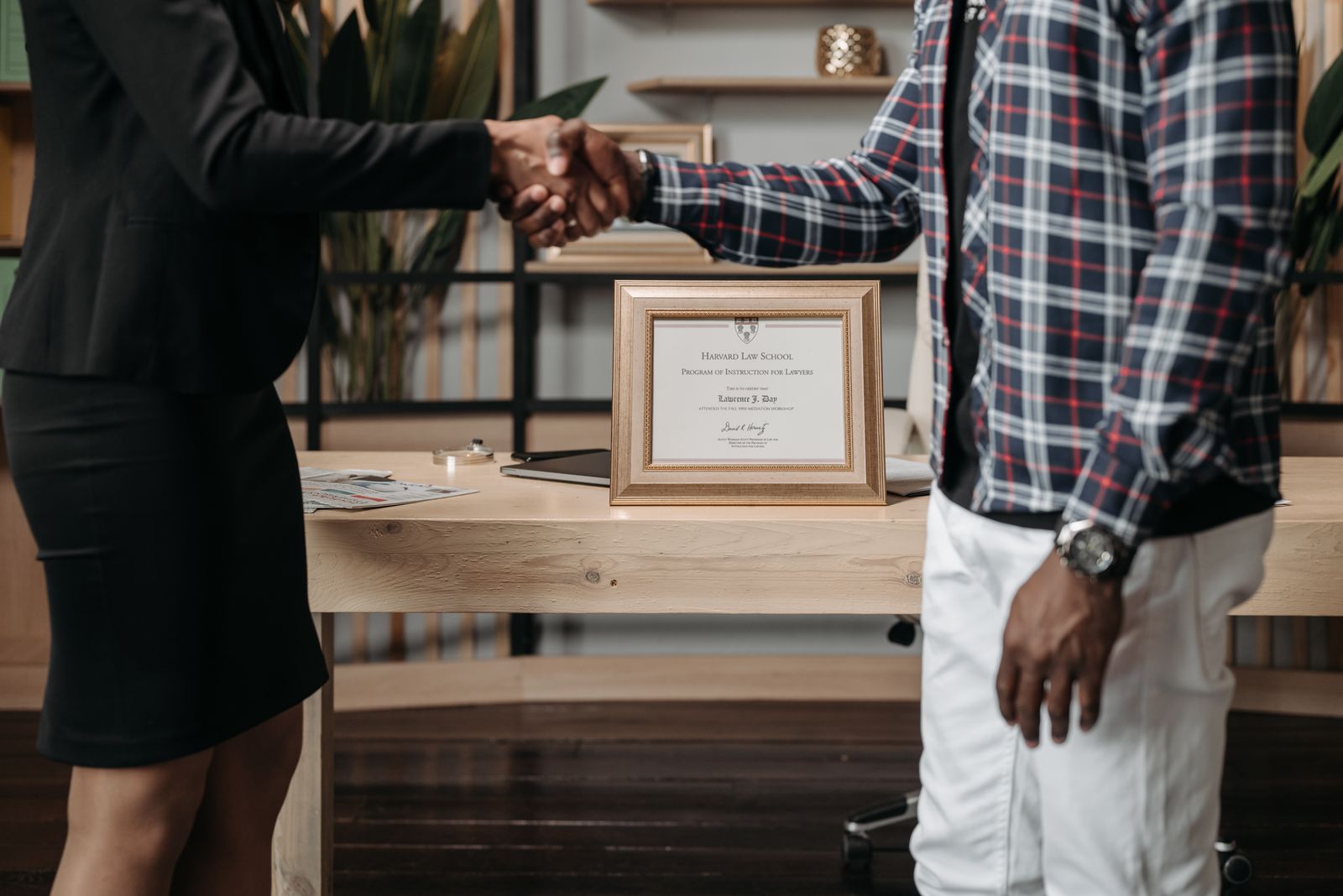 Attorney and client shaking hands after closing a deal