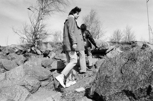 Free A black and white photo of two people hiking over rocky terrain in autumn. Stock Photo