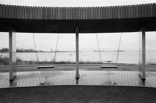 Monochrome Photo of Swings on Riverside 