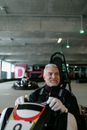 Ederly Man riding a Kart Wheel