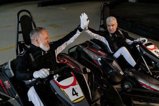 Elderly Men riding a Kart Wheel 