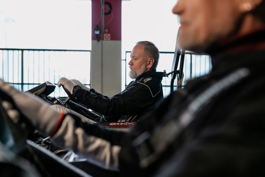 Man in Black Leather Jacket Sitting on Chair