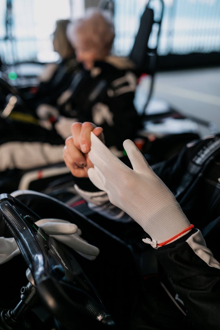 Close-up Photo Of Person Removing White Gloves