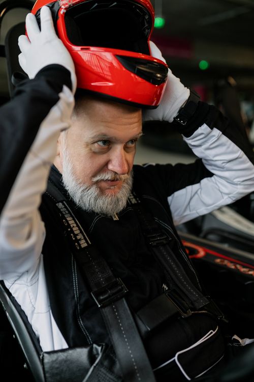 Bearded Men Racing Bearded Man in Racing Suit Holding a Helmet · Free Stock Photo