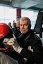 Ederly Man holding a Helmet