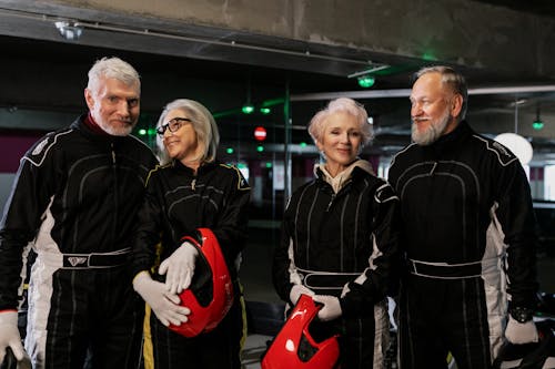 Elderly People Wearing Black Racing Suit Smiling 