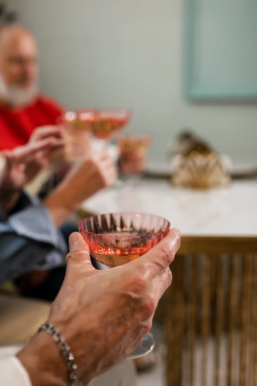 Person Holding Clear Drinking Glass