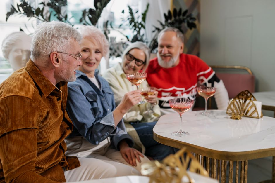 Seniors socializing in a bright common room Seniors socializing in a bright common room