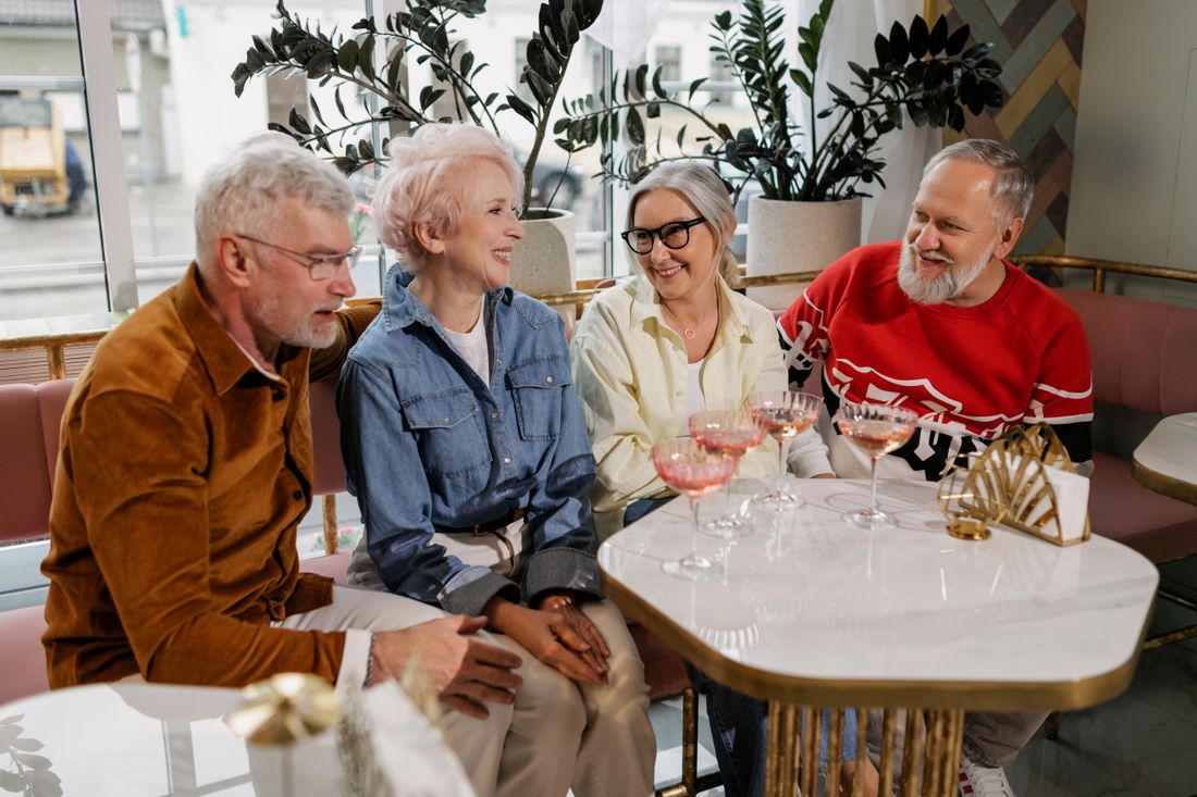 Illustrative photo of older adults enjoying conversation together