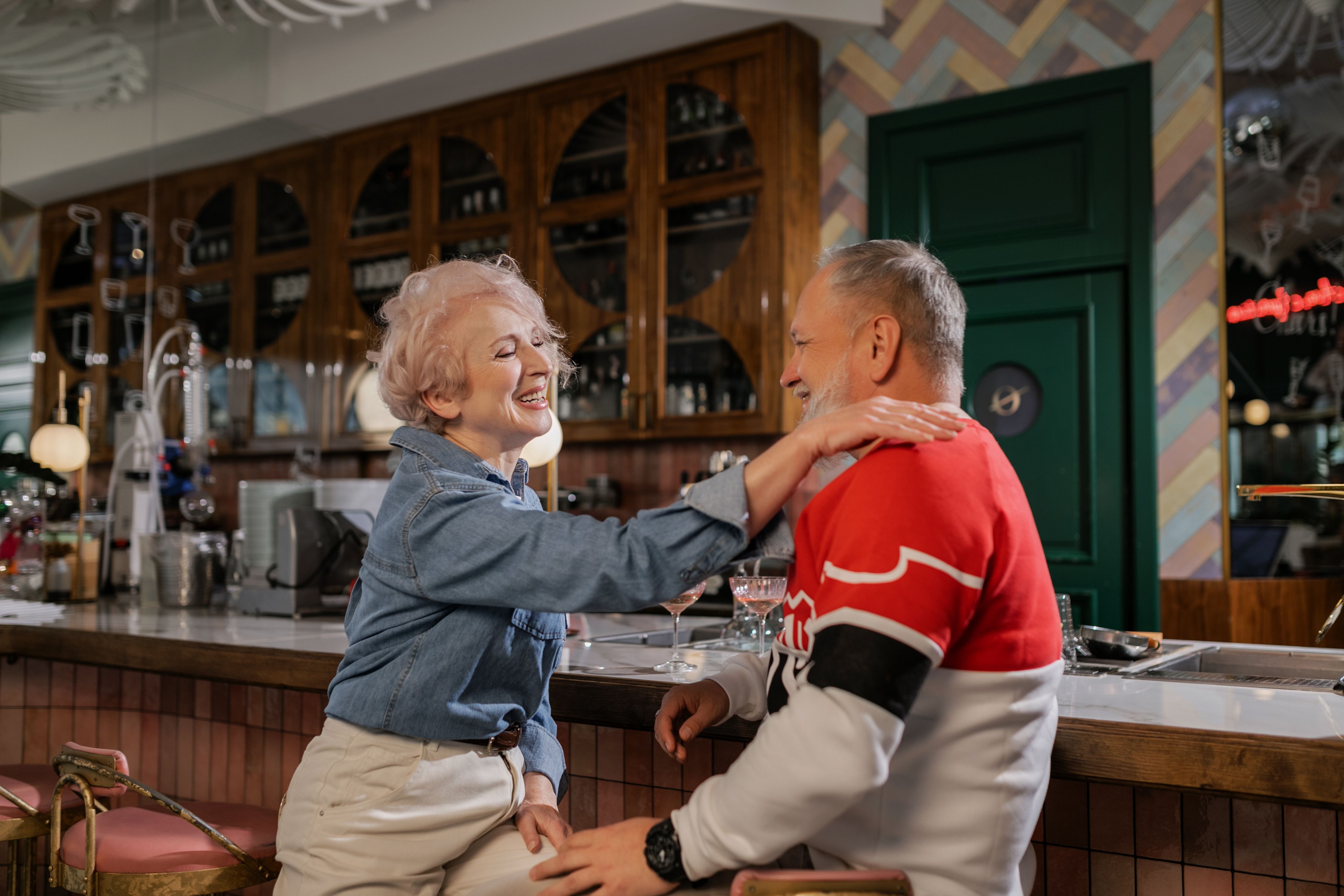 A happy senior couple laughing together in a café