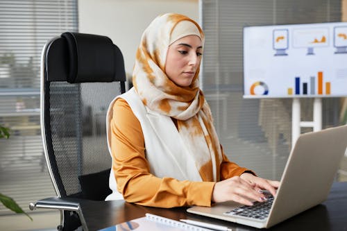 Free A Woman Typing on a Laptop Stock Photo