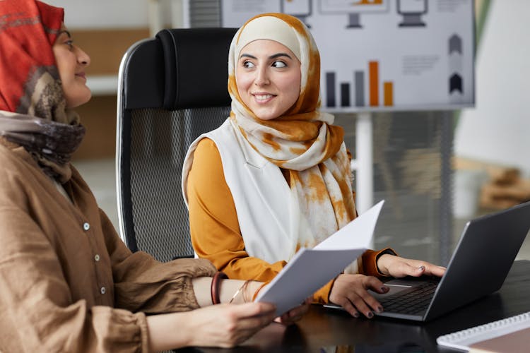 Smiling Woman Holding Her Laptop