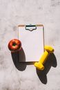 An Apple and a Dumbbell on a Clipboard