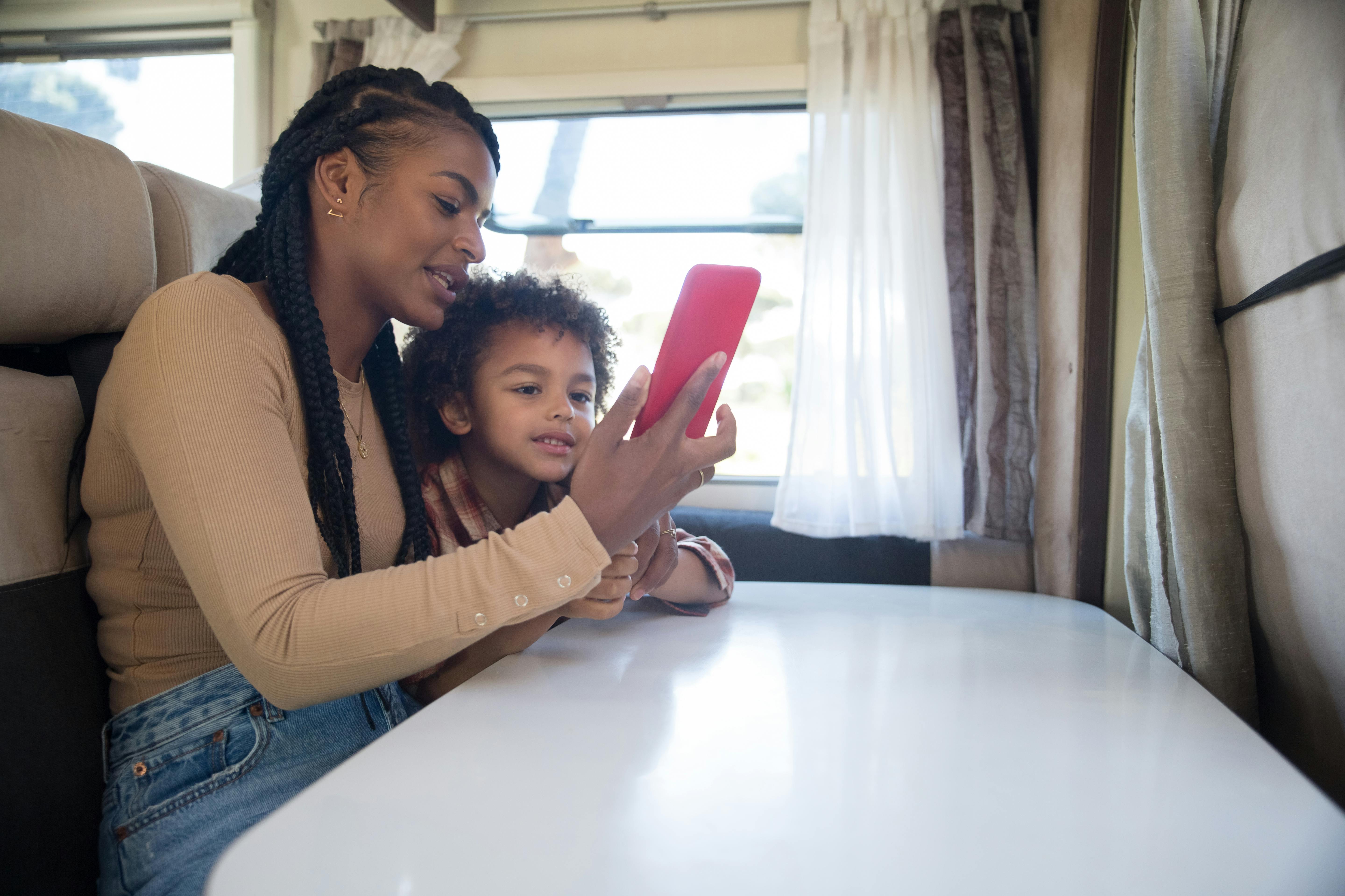 a mother and son looking the smartphone