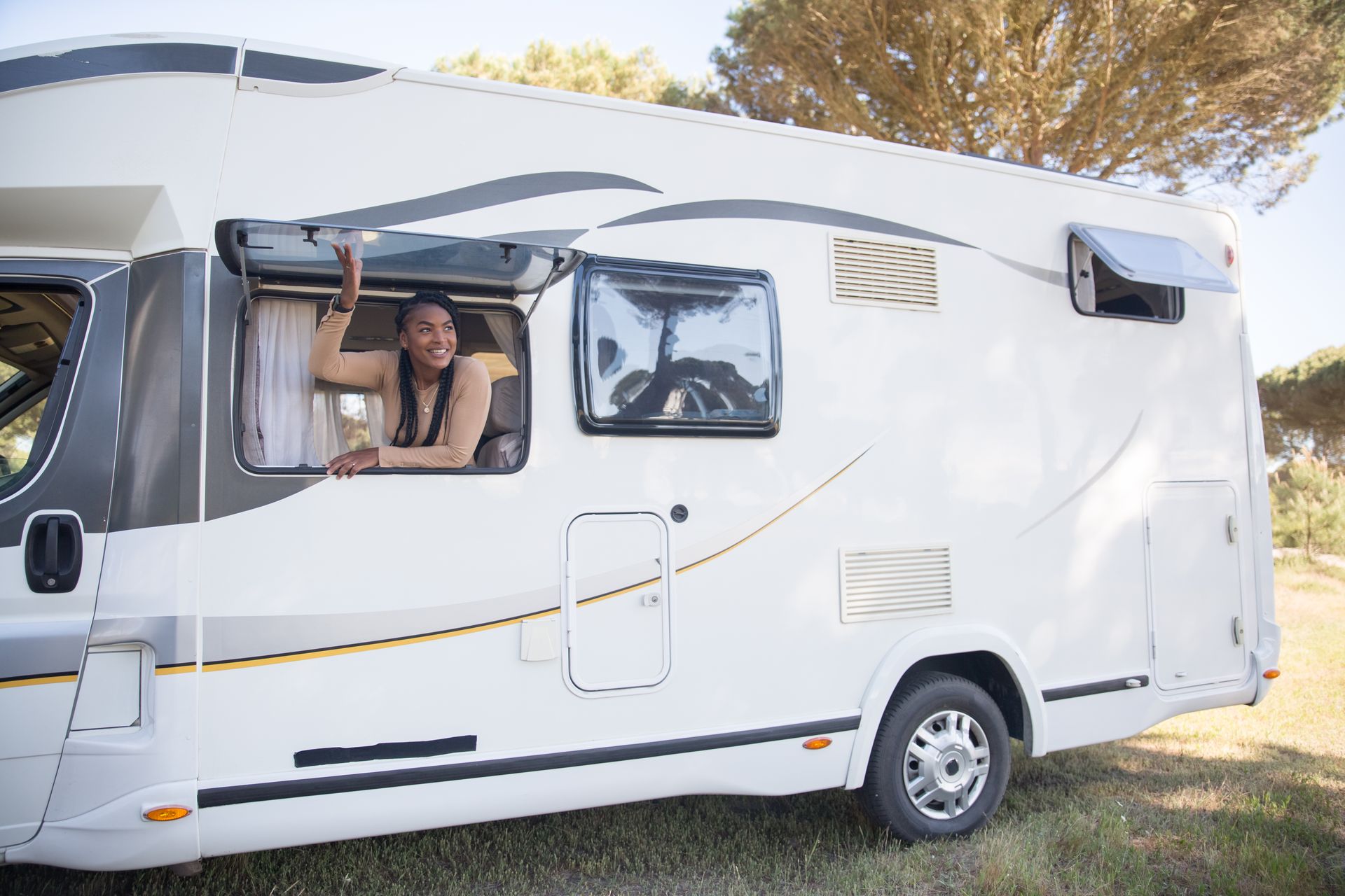 A Woman Sitting Beside the Caravan Window