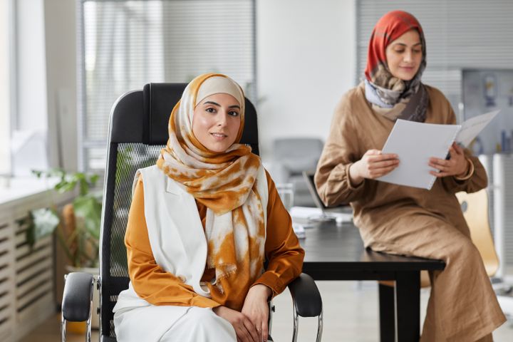 Two colleagues discussing a document in a bright office