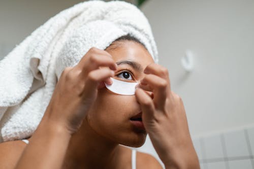 Woman Putting An Under Eye Mask