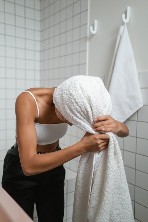 Free Woman Wrapping Her Hair With Bath Towel Stock Photo
