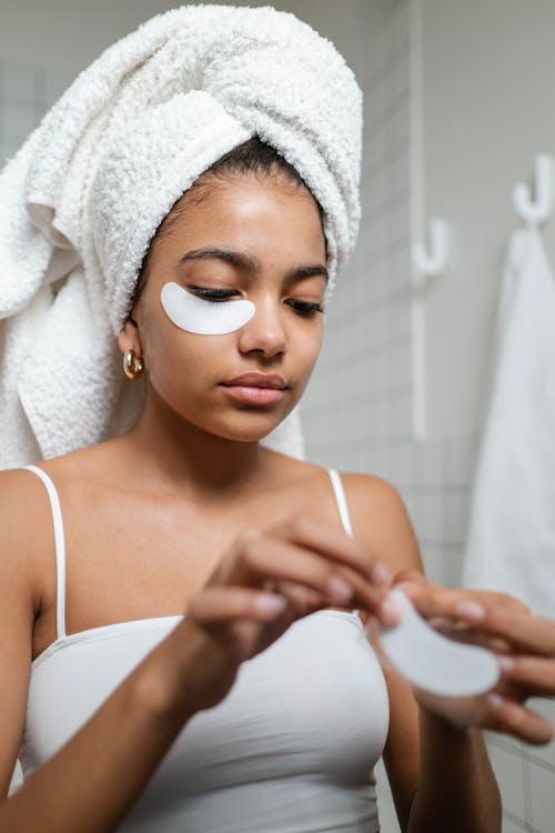 Woman in White Tank Top Putting Under Eye Masks