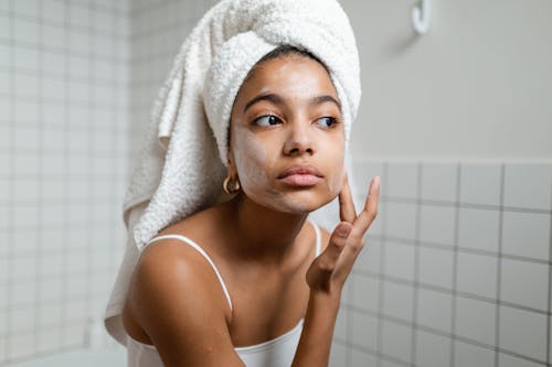 Free Woman Applying Face Cream Stock Photo