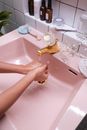 Person Washing Hand on Sink
