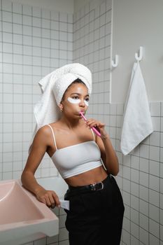 A woman performs her morning routine in a tiled bathroom, adding a fresh start to the day.