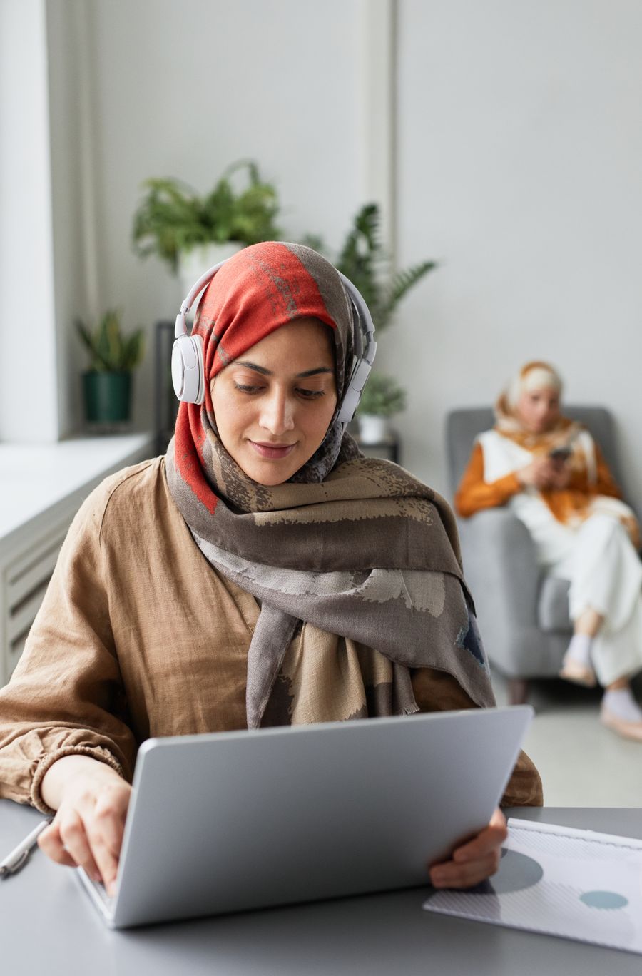 Muslim woman in hijab attending an online session