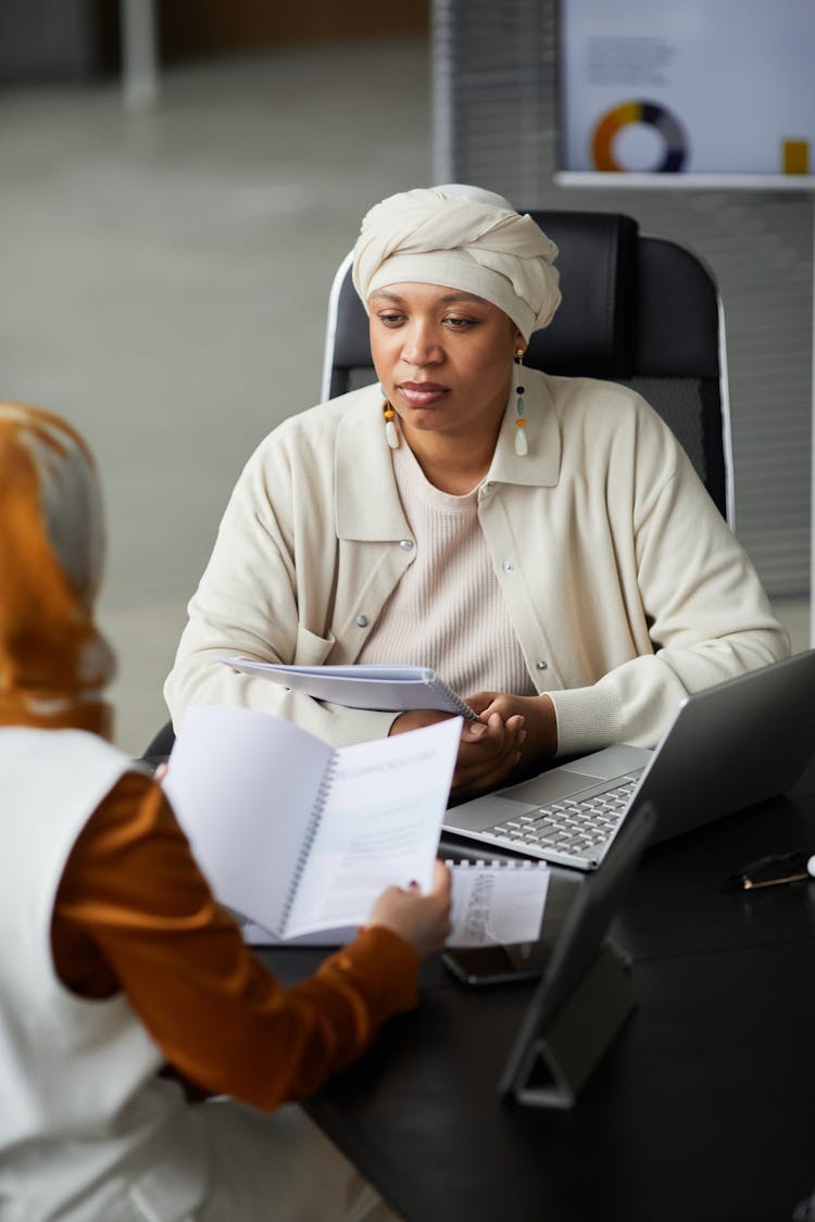 A Woman Listening To Her Colleague In A Meeting