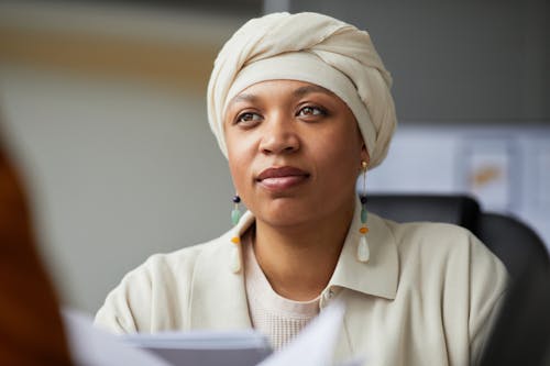 Woman Wearing a White Head Wrap