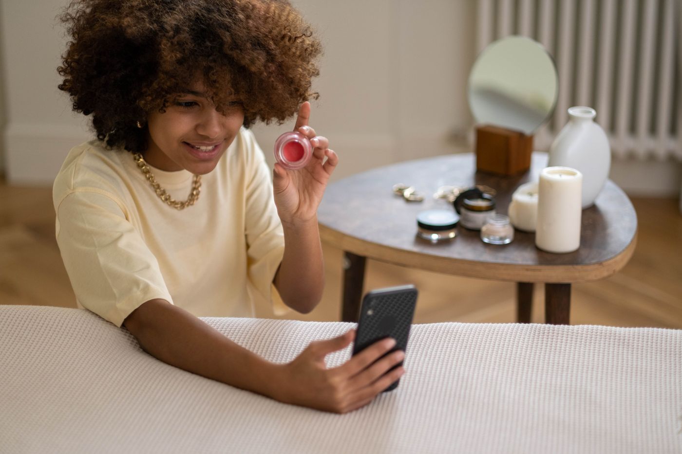 UGC creator filming a beauty product demonstration on a smartphone